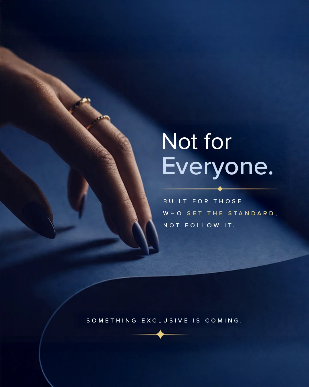 Close-up of a hand with blue nail polish resting on dark blue paper, accompanying text reads: "Not for Everyone" and a teaser for something exclusive coming soon.