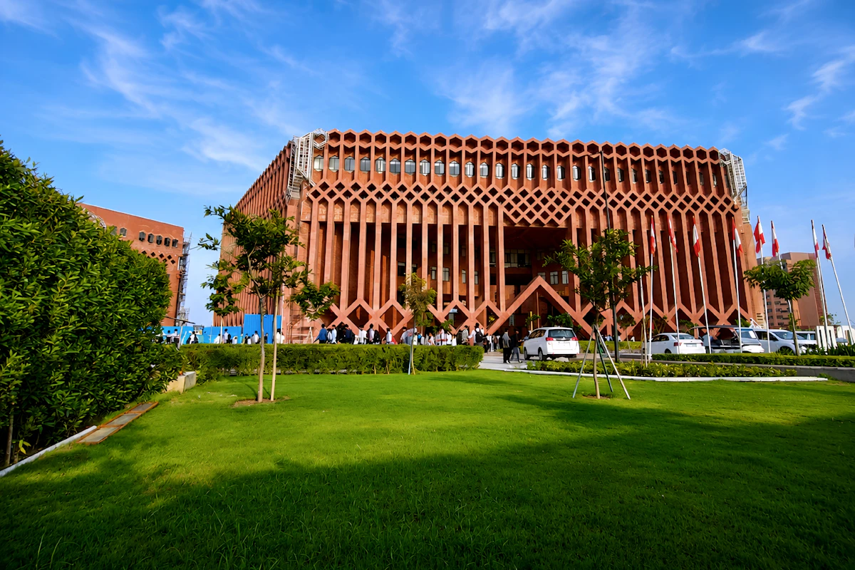 Modern red sandstone commercial building with lawn in Jaipur